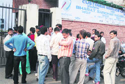 Subscribers queue up outside a BSNL bill payment centre at Gandhi Nagar in Jammu.