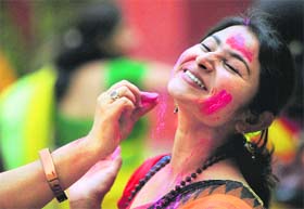 Students of Rabindrabharati University celebrate Basant Utsav in Kolkata on Tuesday. 
