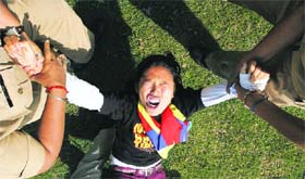 The police detains a Tibetan exile during a protest in front of the Chinese embassy in New Delhi on Tuesday. Dozens of exiled Tibetans protested on Tuesday to<p>mark the 51st anniversary of the Tibetan uprising against China.