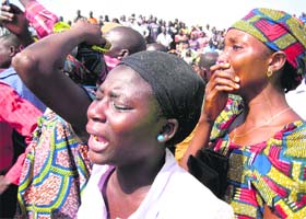Women react to the sight of bodies in Dogo Nahwa