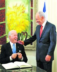 Israeli President Shimon Peres (right) laughs with US Vice-President Joseph Biden after signing the guest book ahead of their meeting in Jerusalem
