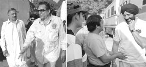 Bollywood actor Dharmendra and Sunny Deol with fans, during the shooting of film Yamla Pagla Diwana, directed by Sameer Karnik, at a village near Patiala on Wednesday. 