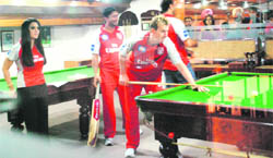 King XI Punjab player Brett Lee plays billiards with Preity Zinta at the PCA Stadium in Mohali on Wednesday.