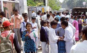 Students of Haryana board stand outside an examination centre after their exam was cancelled in Faridabad