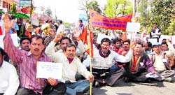 Sugar mill workers protest outside the state Assembly in Dehradun on Wednesday