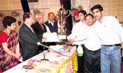 Representatives of Acme Tractors, Rudrapur, receive the best stall trophy at the farmers fair at Pant Nagar on Tuesday