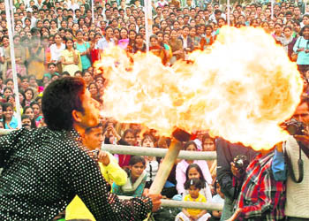 An artiste performs a fire trick at the union week celebrations of DAV PG College in Dehradun 