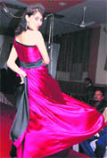 A student showcases a dress created by fellow designers at a fashion show in Haridwar