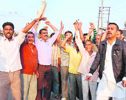 Rehriwallas protest against the JDA authorities outside the railway station in Jammu on Thursday. 