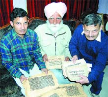 Rajnish Khosla (right) and Dr Harbans Lal Bawa show the manuscripts.