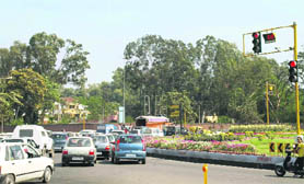 Motorists jump a red light Friday in the absence of any traffic cops on duty at a rotary near the Sector 20-C gurdwara in Chandigarh. The CCTV cameras have yet to begin functioning.