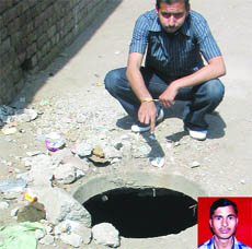 The manhole in east Delhi where Devender (inset) fell and died on Friday.