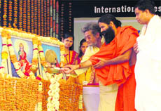 Baba Ramdev, Dr Pranav Pandya and Acharya Bal Krishan light the lamp on the fifth day of the International Yoga Festival at the Dev Sanskriti University in Haridwar on Friday.
