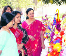 Judges of a flower arrangement competition examine works of participants at BHEL near Haridwar on Friday.
