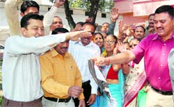 Members of the Uttarakhand Andolankari Sanyukat Parishad burn copies of the government order in Dehradun on Friday. Tribune photographs