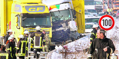 Piling along the highway: Crashed cars stand on the highway in Friedberg (Germany) after a mass car accident. As many as 21 trucks and 37 cars crashed due to fog