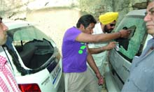 People see the cars that were damaged in the shoot-out. 