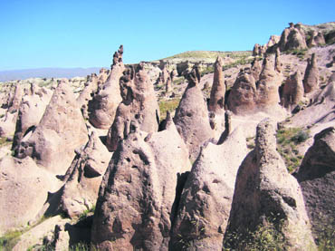Cappadocia was covered with volcano ash. In due course of time, natural elements chipped away the mounds and left these conical hills made of cooled lava