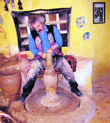 An artist at the potters wheel creating artefacts using the same techniques as those of the Hittites