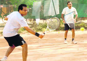 Players in action during the above-35 category tennis doubles match at YMCA, Sector 11, Chandigarh, on Sunday.