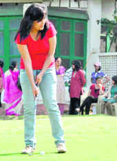 A woman golfer participates in the Sara Golf Tournament held at the FRI golf course in Dehradun on Sunday.