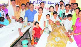 Randeep Singh Mahiya and his wife Sona Devi donate blood on the occasion of the marriage of their three children at Godkan village in Sirsa