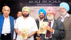 Dr Kirpal Singh (second from right) releases Capt Amarinder Singhs book The Last Sunset as eminent journalists MJ Akbar (left) and Kanwar Sandhu look on, in Chandigarh on Sunday. Tribune photo: Pradeep Tiwari