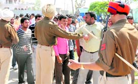 Members of one of the two warring communities being intercepted by the police from marching towards the site of tension in Noorwala on Sunday. Tribune photo: Himanshu Mahajan