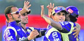 Kolkata Knight Riders players celebrate the wicket of Virat Kohli on Sunday.