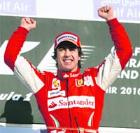 Fernando Alonso celebrates on the podium after winning the Bahrain GP on Sunday.