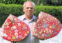 Satpal Bansal with his blood donation badges.
