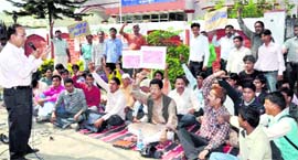 Employees of the Transport Department protest in Dehradun on Monday.
