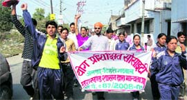Yoga teachers hold a protest in support of their demands in Dehradun on Monday.