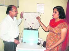 PNDT nodal officer Dr OP Dabas and Dr Usha Mathur seal an ultrasound machine at Maya Hospital in Kosli. 