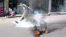 A member of the J&K PoK Refugees Front kicks a tear gas shell during a protest in Jammu on Monday.