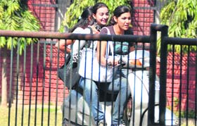 THROWING SECURITY TO WIND: Girls flout driving norms on the PAU campus in Ludhiana