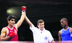 Vijender Singh (L) is declared winner against Tanzania's Selemani Kidunda during semifinals of 75 kgs category at 5th Commonwealth Boxing Championship in New Delhi on Monday. 
