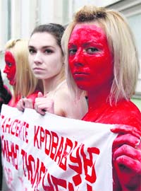 Activists from the People for the Ethical Treatment of Animals protest in front of the Canadian embassy in Moscow