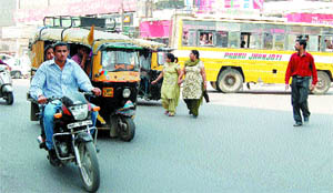 Pedestrians play with danger while crossing one-way designated Queens Road, which does not have zebra crossing, in Amritsar.