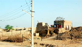 The Archeological Survey of India has covered open space in the Mud Fort area by wire. A partly demolished house gets isolated.
