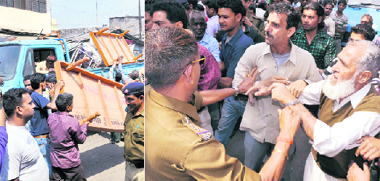 An anti-encroachment drive in progress; and (right) shopkeepers argue with police personnel during the drive in Dehradun on Tuesday.