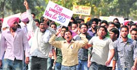 Protesting students of GADVASU hold banners demanding justice during a protest rally in Ludhiana on Tuesday.