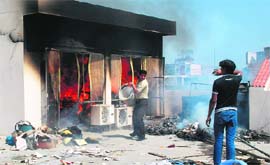 Residents douse the fire at Model Town in Ludhiana on Tuesday.