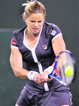 Kim Clijsters returns a shot against Alisa Kleybanova during their match at the Indian Wells WTA tennis tournament in Indian Wells, California