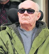 Accused Nazi death camp guard John Demjanjuk sits in a wheelchair as he arrives in a courtroom in Munich on Tuesday. Demjanjuk is on trial in Germany facing charges he helped force 27,900 Jews into gas chambers in Sobibor extermination camp in 1943.  Reuters