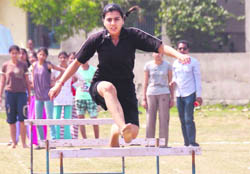 A girl takes part in a hurdle race during the annual sports day of Government Polytechnic for Women, Ludhiana, on Wednesday.