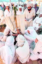 Mandaeans perform rituals under a parasol on the first day of the Benja festival in Baghdad on Wednesday. Benja is a five-day religious holiday celebrated by Mandaeans, a monotheistic religion historically practised around the lower Euphrates and Tigris