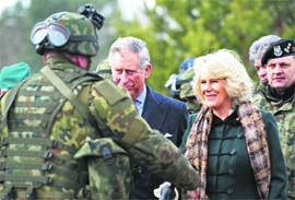 Britain's Prince Charles (C) and his wife Camilla, the Duchess of Cornwall, talk to soldiers at a military base in Wesola, near Warsaw, Poland, on Wednesday