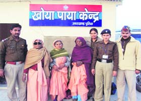 Some elderly persons, who got lost at the Kumbh Mela, and police officials in front of the lost-and-found cell at Haridwar