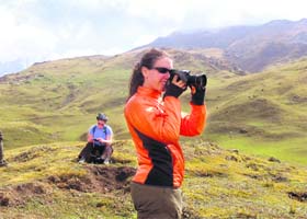 A foreigner captures the beauty of Gorson meadow in her camera in Chamoli district of Garhwal